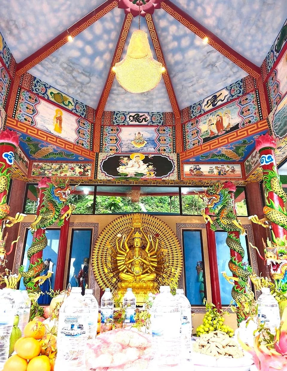 Crystal chandeliers in temple hall with monk